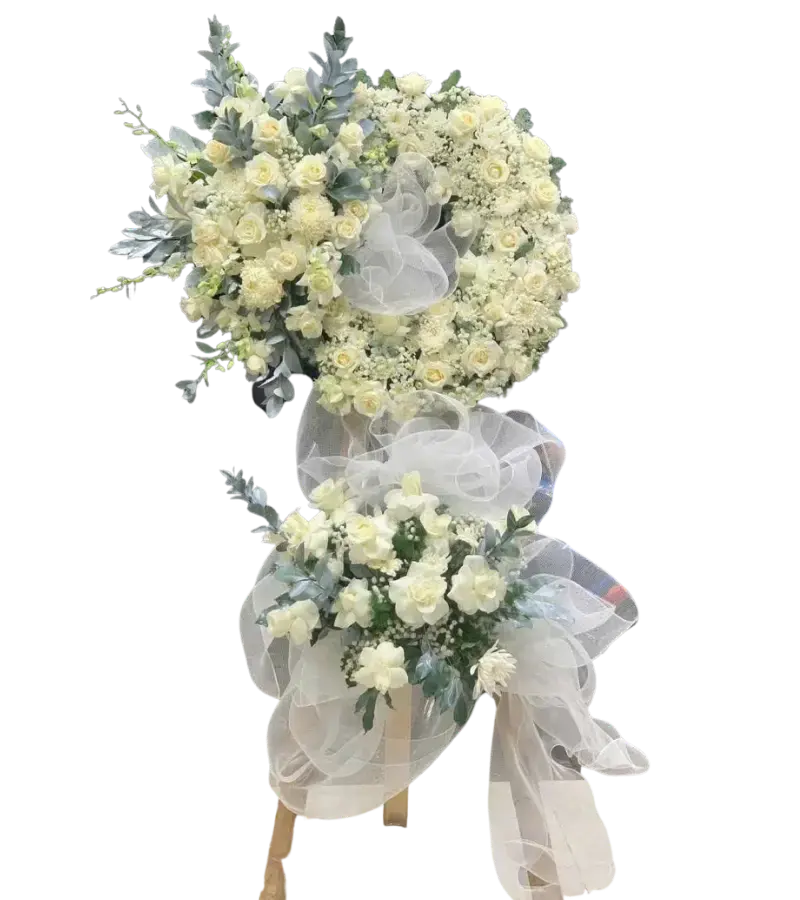Kệ hoa chia buồn hồng kem cúc trắng và hoa baby